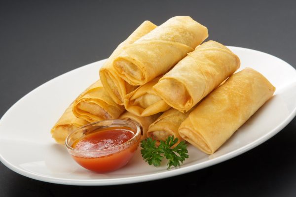 Spring Rolls Spring rolls platter with 12 - 24 mini golden vegetable and chicken spring rolls arranged on a round tray, ready to serve.